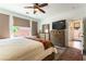 Well-lit bedroom with neutral tones, ample storage with large dresser and access to ensuite bathroom at 3621 Jasmine Heights Ave, North Las Vegas, NV 89081