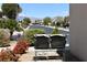 Cozy front yard with desert landscaping, charming bench, and views of mountains in the distance at 3621 Jasmine Heights Ave, North Las Vegas, NV 89081
