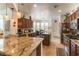 Well-lit kitchen with granite countertops, stainless steel appliances, and an island at 3621 Jasmine Heights Ave, North Las Vegas, NV 89081