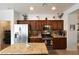 Modern kitchen with granite countertops and stainless steel appliances, next to the laundry area at 3621 Jasmine Heights Ave, North Las Vegas, NV 89081