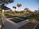 Community lawn bowling with shade structures and mature palm tree landscaping at 3621 Jasmine Heights Ave, North Las Vegas, NV 89081