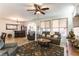 Inviting living room featuring a large sectional sofa, and a stylish wet bar at 3621 Jasmine Heights Ave, North Las Vegas, NV 89081