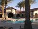 Inviting community pool and lounge area shaded by palm trees at 3621 Jasmine Heights Ave, North Las Vegas, NV 89081
