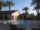 Community pool with lounge chairs and umbrellas surrounded by lush landscaping at 3621 Jasmine Heights Ave, North Las Vegas, NV 89081