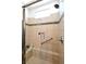 Accessible shower with neutral tiles, a built-in bench, and convenient grab bar for enhanced safety and comfort at 3621 Jasmine Heights Ave, North Las Vegas, NV 89081