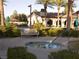 Relaxing hot tub area with bench and community pool in background at 3621 Jasmine Heights Ave, North Las Vegas, NV 89081