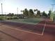 Tennis court with green court and mature trees in background at 3621 Jasmine Heights Ave, North Las Vegas, NV 89081