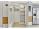 Walk-in closet features mirrored doors, shoe rack, shelves, and ample storage at 3726 Las Vegas Blvd # 1809, Las Vegas, NV 89158