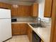 Bright kitchen featuring wood cabinets, tile countertops, and stainless steel sink at 4113 Arcola Ave, Las Vegas, NV 89110
