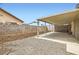 Backyard with a covered patio, rock garden, and block wall at 4611 Four Leaf Clover Dr, Las Vegas, NV 89122