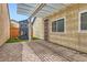 Backyard with covered patio, brick flooring, and a fun playhouse at 4611 Four Leaf Clover Dr, Las Vegas, NV 89122