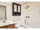 Bathroom featuring a shower over tub combo and vanity with storage at 4611 Four Leaf Clover Dr, Las Vegas, NV 89122