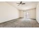 This spacious bedroom features a ceiling fan and sliding glass door at 4611 Four Leaf Clover Dr, Las Vegas, NV 89122