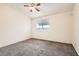 This carpeted bedroom offers natural light and neutral walls at 4611 Four Leaf Clover Dr, Las Vegas, NV 89122