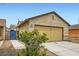 Charming one-story home featuring a two-car garage and desert-friendly landscaping at 4611 Four Leaf Clover Dr, Las Vegas, NV 89122