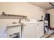 Functional laundry room with utility sink, washer, and dryer at 4611 Four Leaf Clover Dr, Las Vegas, NV 89122