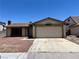 Single-story home featuring a two-car garage and low maintenance landscaping at 4766 Knollwood Dr, Las Vegas, NV 89147