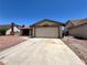 Single-story home featuring a two-car garage and low maintenance landscaping at 4766 Knollwood Dr, Las Vegas, NV 89147