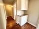 Hallway with built-in cabinets and hardwood floors at 4766 Knollwood Dr, Las Vegas, NV 89147
