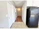 View of the kitchen featuring tile floor and access to hallway with wood-look flooring at 4766 Knollwood Dr, Las Vegas, NV 89147