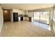 Open-concept kitchen featuring tile floors, white cabinets, and sliding door access to the backyard at 4766 Knollwood Dr, Las Vegas, NV 89147