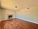 Cozy living room featuring a classic fireplace and wood-look flooring at 4766 Knollwood Dr, Las Vegas, NV 89147