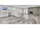 Spacious living area featuring wood floors, a fireplace, and lots of natural light at 4813 Plata Del Sol, Las Vegas, NV 89121