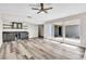 Living room with bar, large windows providing lots of light and gray wood-look floors at 4813 Plata Del Sol, Las Vegas, NV 89121