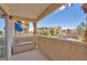 A covered outdoor patio features seating and views of the community grounds and nearby buildings at 5012 Newport Cove Dr # C, Las Vegas, NV 89119