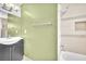 Bathroom features tiled shower-tub and dark vanity with bright fixtures at 5012 Newport Cove Dr # C, Las Vegas, NV 89119