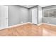 This bedroom has light gray walls, wood-look flooring, and a window at 5012 Newport Cove Dr # C, Las Vegas, NV 89119