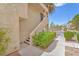 Exterior view of the residential building's entry staircase, framed by lush greenery and a clear sky at 5012 Newport Cove Dr # C, Las Vegas, NV 89119