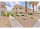 Exterior view of the apartment buildings with well-maintained landscaping and gravel ground cover at 5012 Newport Cove Dr # C, Las Vegas, NV 89119