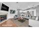Living room with a fireplace and open to kitchen, featuring a modern island at 5012 Newport Cove Dr # C, Las Vegas, NV 89119