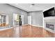 Spacious living room with fireplace, hardwood flooring, and outdoor access at 5012 Newport Cove Dr # C, Las Vegas, NV 89119