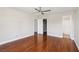 Spacious bedroom with wood laminate flooring, ceiling fan, and view to the bathroom at 5063 Eldora Ave # 4, Las Vegas, NV 89146