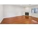 Bright living room with hardwood floors, a fireplace, and large window at 5063 Eldora Ave # 4, Las Vegas, NV 89146