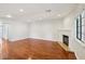 Spacious living room featuring gleaming hardwood floors and a classic fireplace at 5063 Eldora Ave # 4, Las Vegas, NV 89146