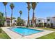 Community pool with bright blue water and surrounding community buildings at 5063 Eldora Ave # 4, Las Vegas, NV 89146