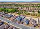 Aerial view of home with neighboring houses and golf course in the background at 5357 Eleganza Ave, Pahrump, NV 89061