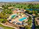 Gorgeous aerial perspective of community pool, golf course, and lush landscaping with mountain views at 5357 Eleganza Ave, Pahrump, NV 89061