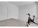 Cozy bedroom featuring neutral tones, closet, and indoor bike at 5357 Eleganza Ave, Pahrump, NV 89061