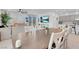 Open-concept dining area featuring a large table, modern decor, and seamless flow to the living and kitchen spaces at 5357 Eleganza Ave, Pahrump, NV 89061