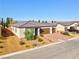Single-story home with a two-car garage and desert landscaping at 5357 Eleganza Ave, Pahrump, NV 89061