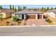 Attractive single-story home with a three-car garage, appealing landscaping and paved driveway at 5357 Eleganza Ave, Pahrump, NV 89061