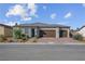 Inviting single-story home with a three-car garage, rock landscaping and appealing front entrance at 5357 Eleganza Ave, Pahrump, NV 89061