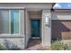 Close-up of the home's front door with textured facade and brick-paved entryway at 5357 Eleganza Ave, Pahrump, NV 89061