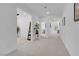 Bright, airy hallway with neutral colors and natural light leads to other rooms in the home at 5357 Eleganza Ave, Pahrump, NV 89061