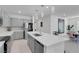 Open concept kitchen with an oversized quartz island, gray cabinetry and stainless steel appliances at 5357 Eleganza Ave, Pahrump, NV 89061