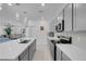 Stylish kitchen with a center island, stainless steel appliances, and an open view to the living room at 5357 Eleganza Ave, Pahrump, NV 89061